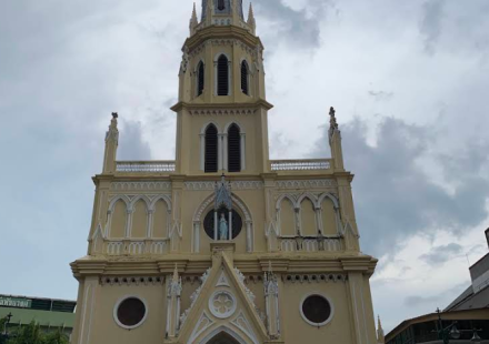 Holy Rosary Church's Gothic Revival spire overlooking the Chao Phraya River in Talat Noi, Bangkok