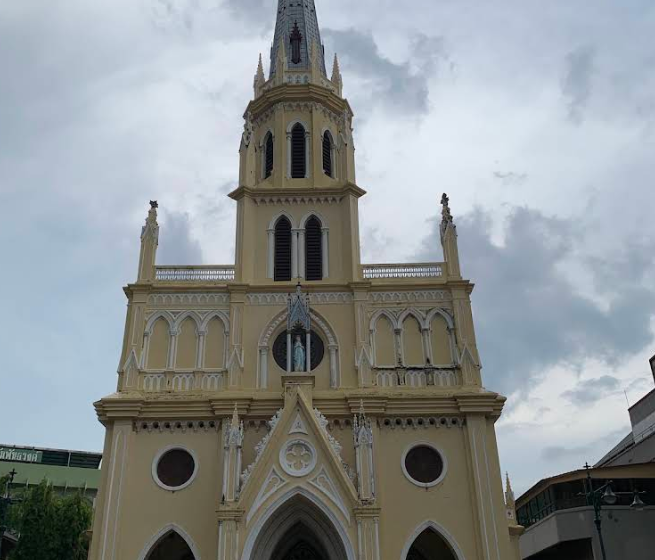 Holy Rosary Church's Gothic Revival spire overlooking the Chao Phraya River in Talat Noi, Bangkok